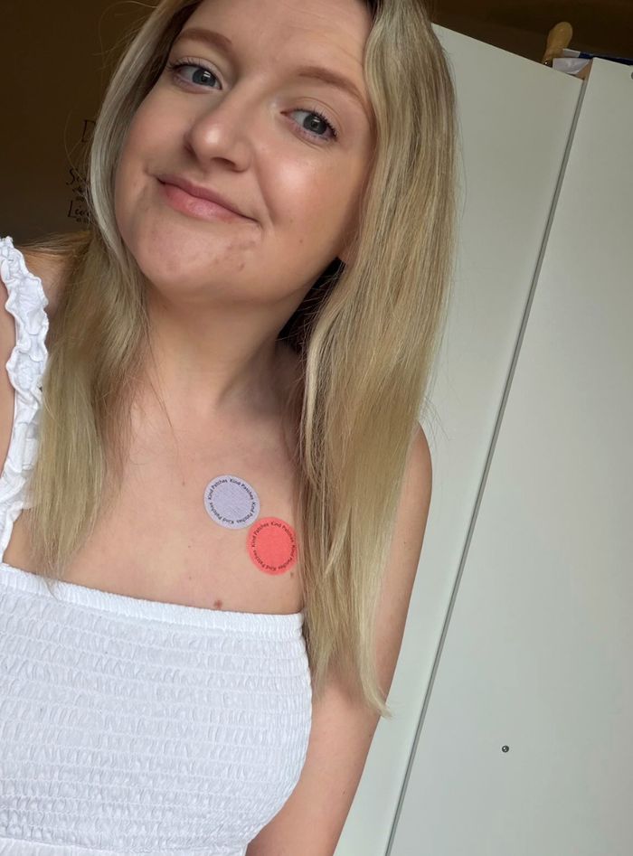 A Kind Patches customer wearing a lilac and a coral patch on her chest